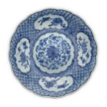 A Chinese blue and white 'lotus' foliate dish with convex centre Qing dynasty, 18th century The...