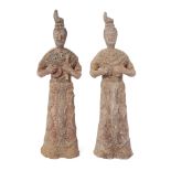 Two Chinese pottery figures of female court musicians Tan dynasty Each modelled standing clutch...