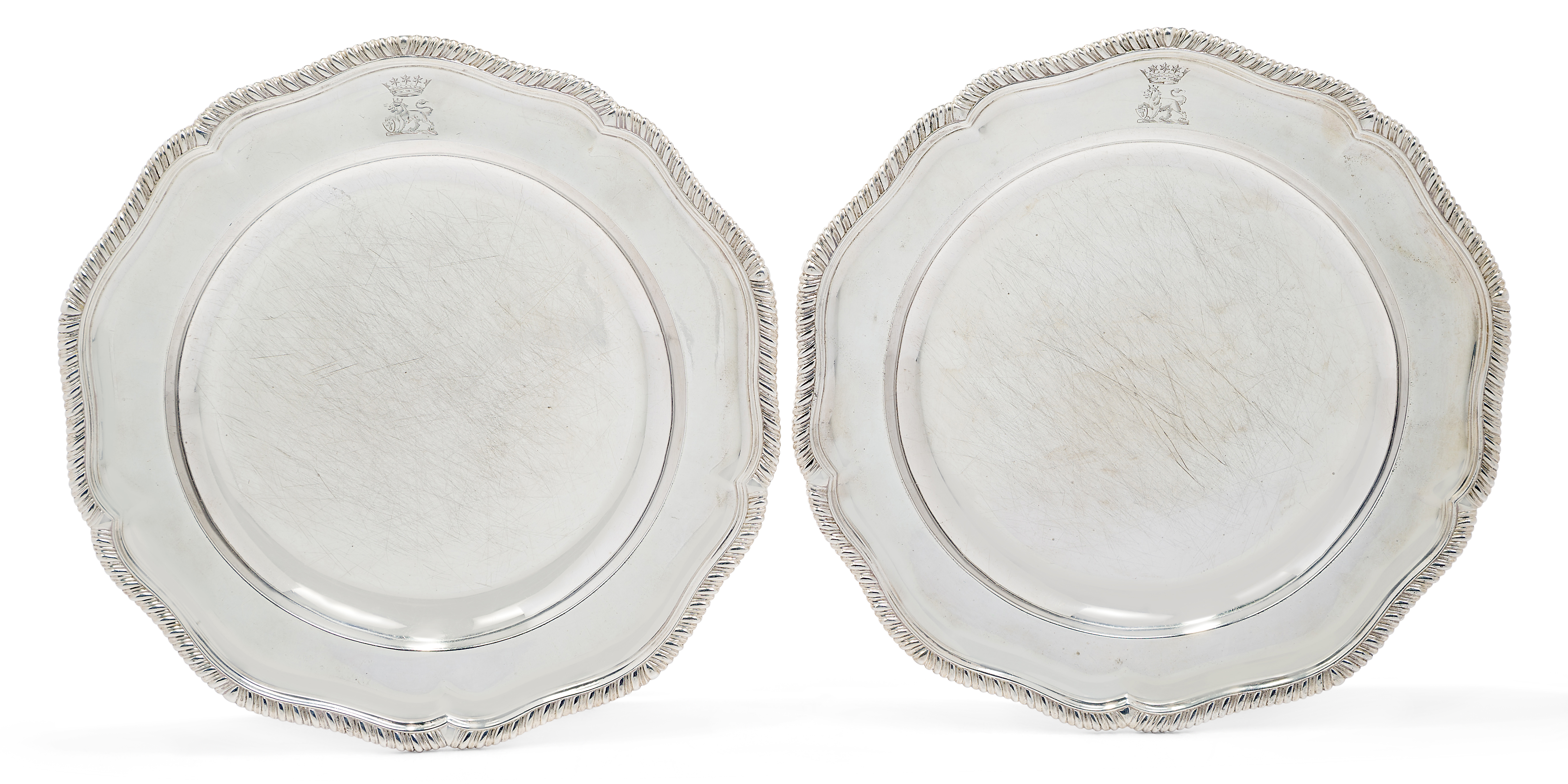 A pair of George III silver dinner plates, London, 1807, Robert Garrard I, of shaped circular for...