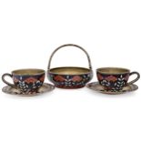 A pair of Soviet 'Rowan berry' pattern enamelled cups and saucers by the Leningrad Jewellery Fact...