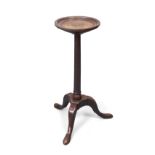 An English oak and mahogany candle stand, in the George II style, part 18th century, the circular...