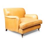 An English tan leather oversized armchair, in the manner of Howard & sons, late 20th century, rai...