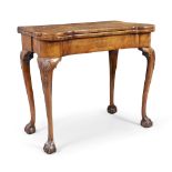 An English walnut card table with concertina action, in the George II style, first quarter 20th c...