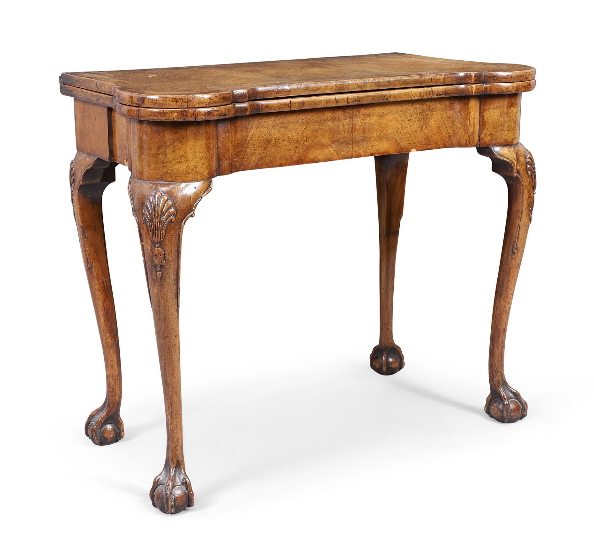 An English walnut card table with concertina action, in the George II style, first quarter 20th c...