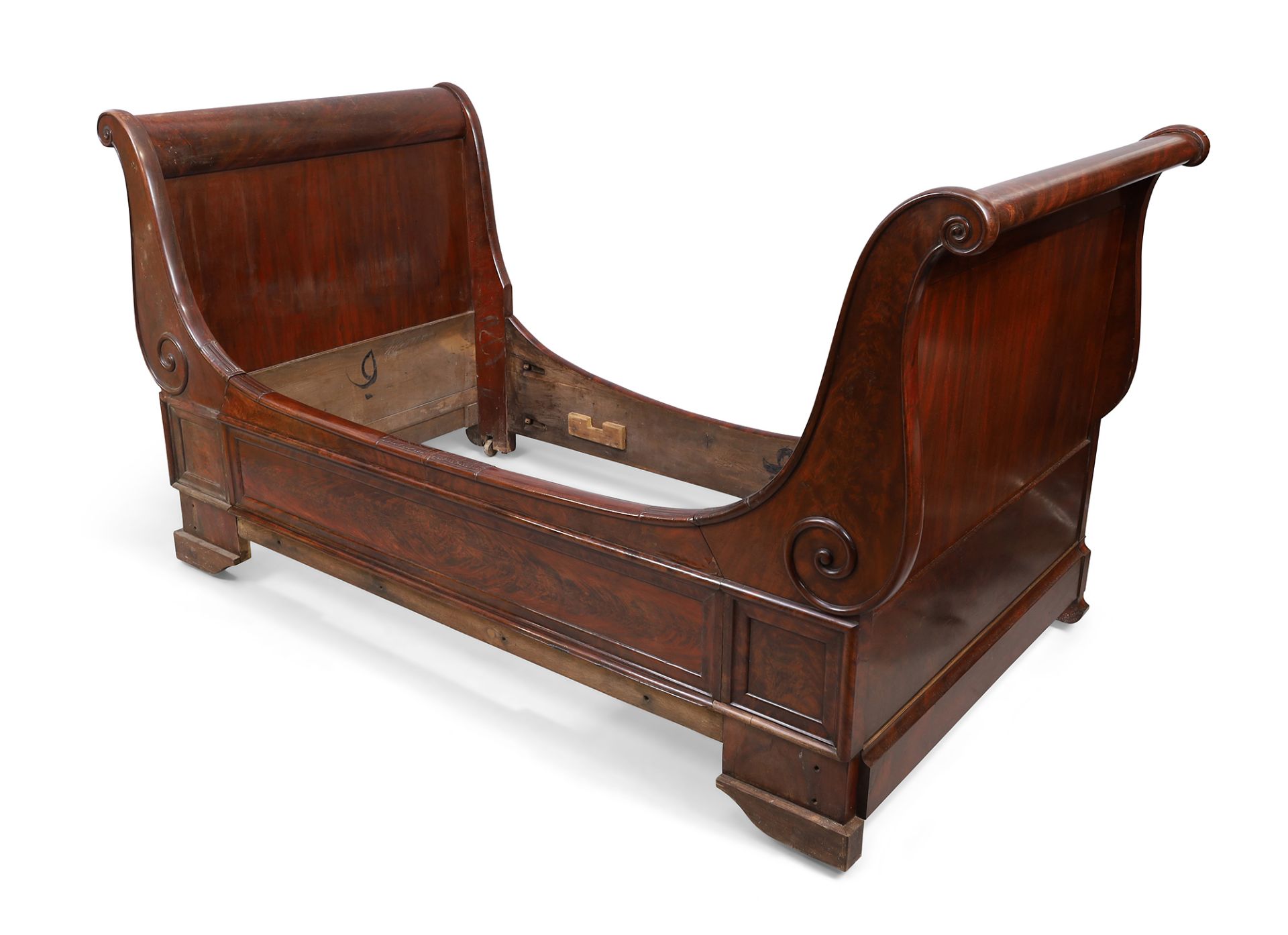 A French mahogany bateau lit, 19th century, with scroll ends and mouldings, 112cm high, 210cm wid...