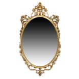 A French giltwood mirror, last quarter 19th century, the moulded oval frame with carved and pierc...