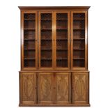A George III mahogany library bookcase, first quarter 19th century, ebony strung, the moulded ste...