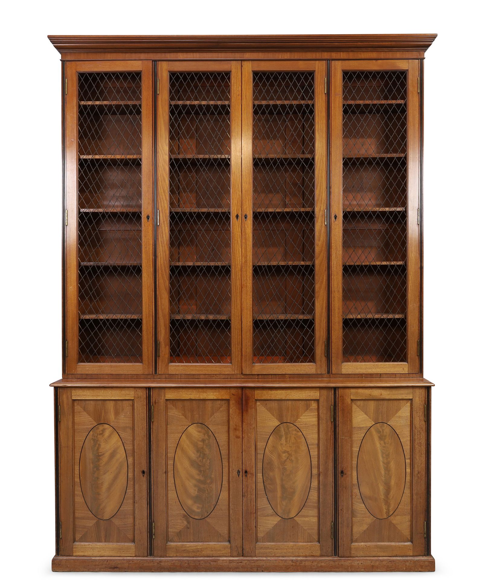 A George III mahogany library bookcase, first quarter 19th century, ebony strung, the moulded ste...