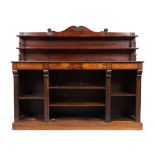 A Regency rosewood bookcase, first quarter 19th century, the two shelf back with shaped top, abov...