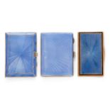 Two blue guilloche enamelled silver cigarette cases and a blue enamelled copper metal snuff box, ...