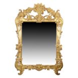 A French giltwood mirror, in the Louis XV style, 20th century, the surmount and frame carved with...