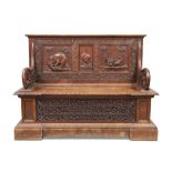 An Anglo-Indian carved oak box settle, third quarter 19th century, the back with three carved pan...