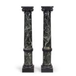 A pair of verde antico marble Ionic pedestal columns, mid 20th century, with black marble capital...