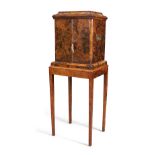 An English walnut cigar cabinet on stand, first quarter 20th century, the rectangular cavetto top...