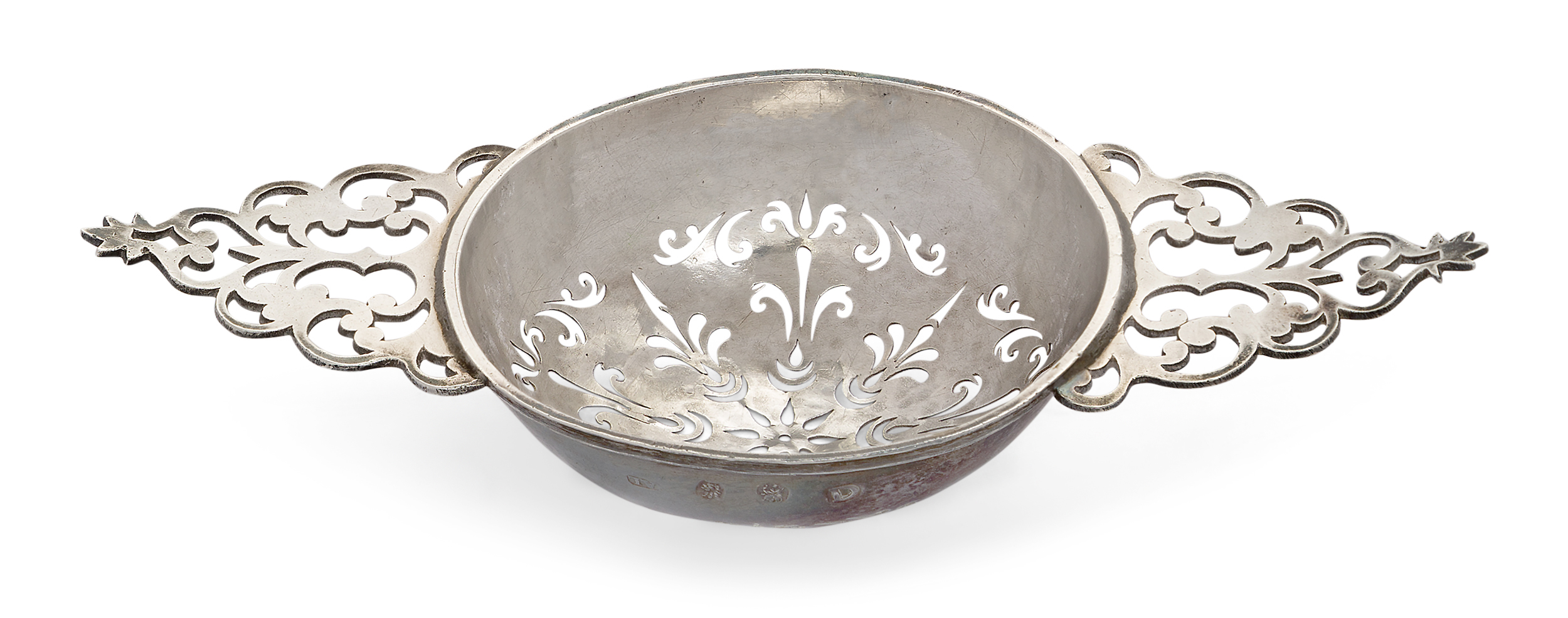 A George I silver lemon strainer, London, 1719, John Albright, with foliate pierced bowl to pierc...