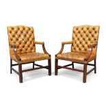 A pair of English mahogany Gainsborough armchairs, in the George III style, 20th century, with ta...