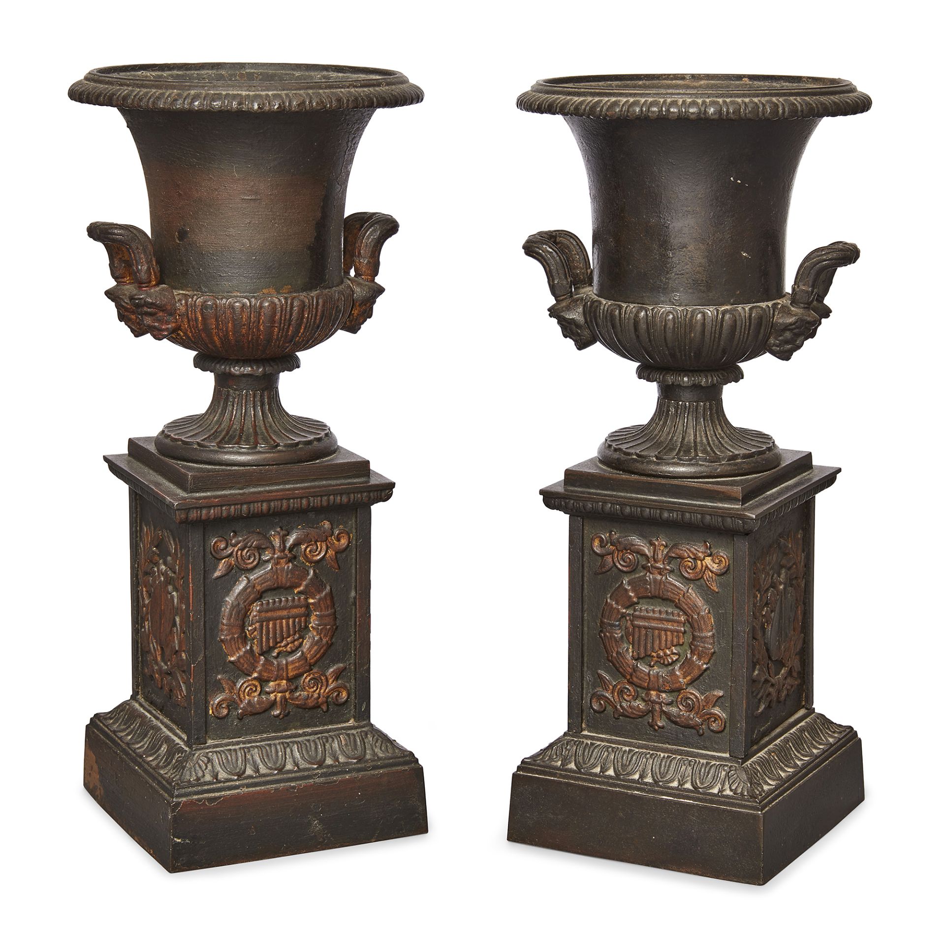 A pair of French cast-iron urns, by Mignon, late 19th century, each with twin mask handles, the s...