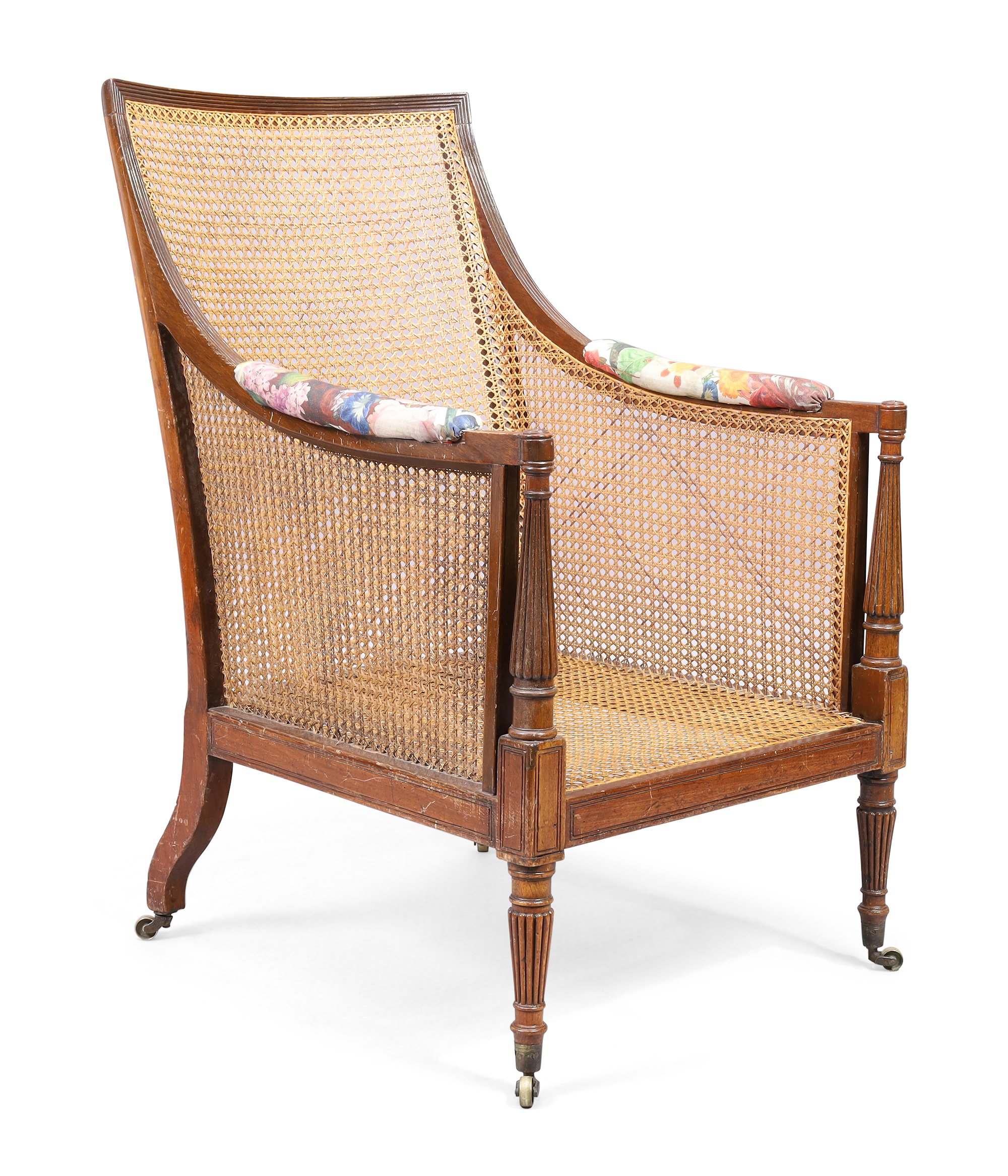 A Regency caned mahogany library armchair, first quarter 19th century, with incised and reeded fr...