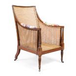 A Regency caned mahogany library armchair, first quarter 19th century, with incised and reeded fr...