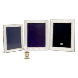 Three silver mounted photo frames, and a small clock, the frames hallmarked Sheffield, 2000, Carr...