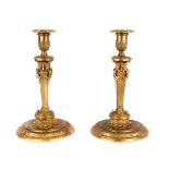 A pair of French ormolu candlesticks, first half 19th century, the acanthus and palmette-cast noz...