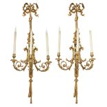 A pair of large French gilt and patinated bronze three-light wall appliques, of Louis XVI style, ...