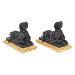 Two modern ebonised resin recumbent female sphinxes, of Louis XVI style, on giltwood bases, 17cm ...