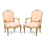 A pair of French carved giltwood fauteuils, in the Louis XV style, first quarter 20th century, pi...