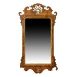 An English walnut and parcel gilt fret work pier mirror, in the George II style, last quarter 19t...