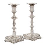 A pair of early George III silver candlesticks, London, 1762, William Cafe, the knopped stems wit...