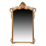 A French giltwood mirror, last quarter 19th century, the shaped to with carved shell crest and sc...