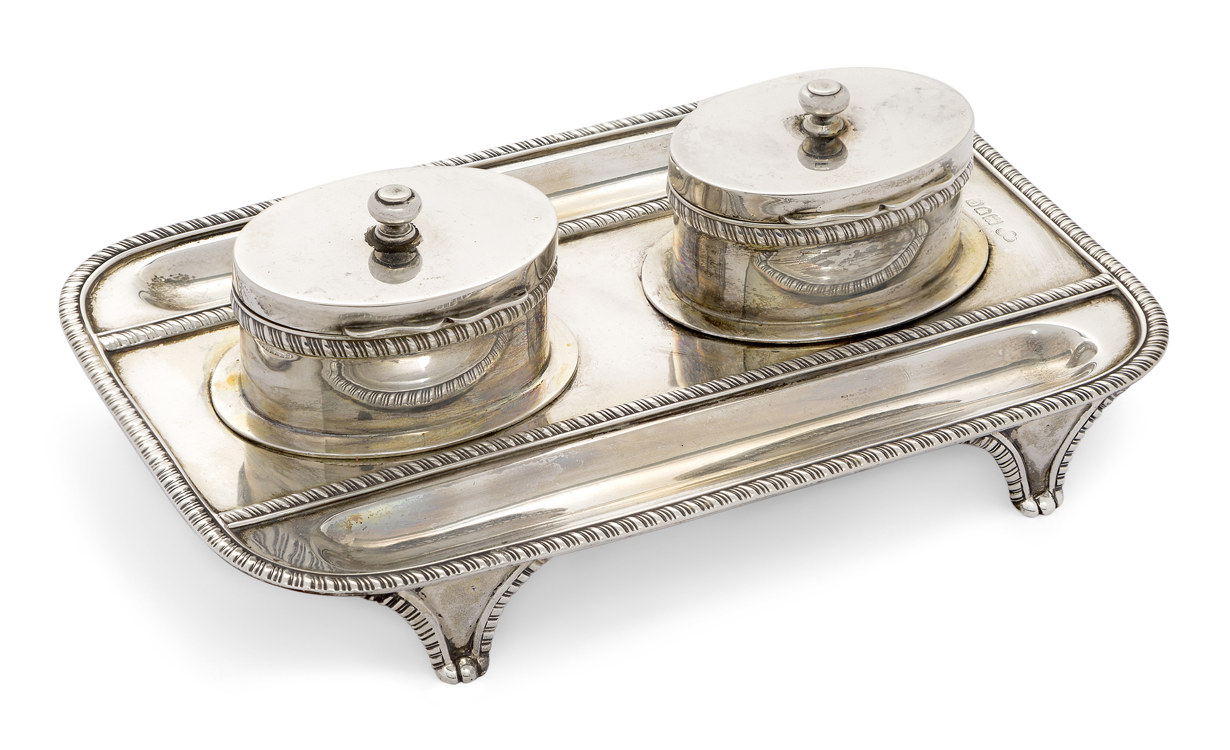 A late Victorian silver inkstand, London, 1900, Goldsmiths & Silversmiths Co., the rectangular st...