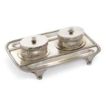 A late Victorian silver inkstand, London, 1900, Goldsmiths & Silversmiths Co., the rectangular st...