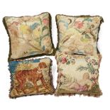 A pair of needlework and silk cushions, incorporating 19th century embroidery, worked in silk wit...