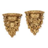 A near pair of English carved giltwood wall brackets, late 19th century, each with shaped shelves...