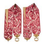 A pair of French red silk bell pulls, of Empire style, late 19th century mounts, decorated with a...