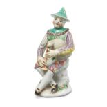 A Longton Hall figure of Harlequin from the Commedia dell’Arte, c.1755-60, wearing a green conica...