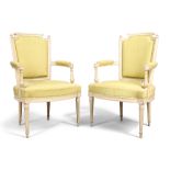 A pair of French painted beechwood fauteuil, in the Louis XVI style, 19th century, the curved arm...