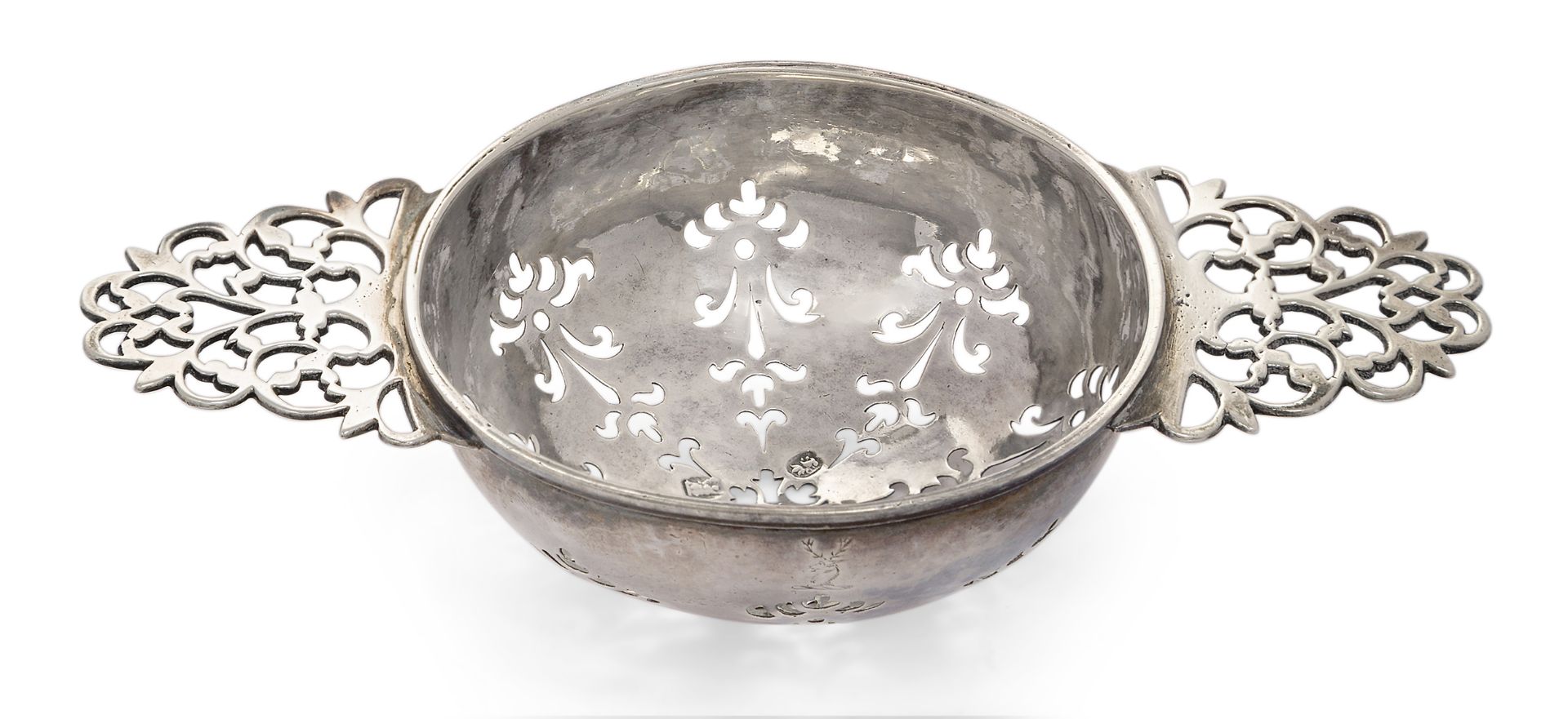 A George I silver lemon strainer, London, 1719, Thomas Bamford, with foliate pierced bowl to open...