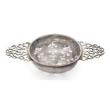 A George I silver lemon strainer, London, 1719, Thomas Bamford, with foliate pierced bowl to open...