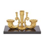 A Regency gilt-bronze desk stand, early 19th century, the well cast as twin addorsed dolphins fla...