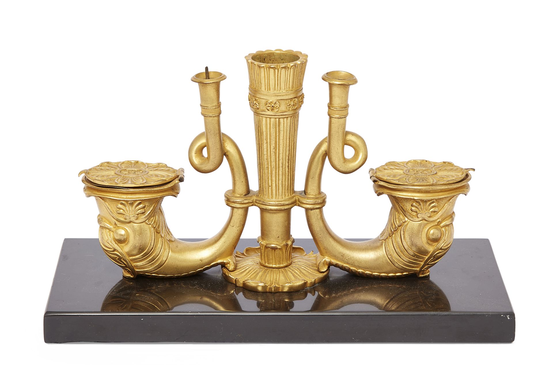 A Regency gilt-bronze desk stand, early 19th century, the well cast as twin addorsed dolphins fla...