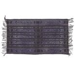 A cotton textile, Indonesia, 20th century, woven in purple and black with stripes containing abst...