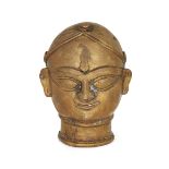 A brass lingam cover in the form of a female head, Maharashtra, 19th century, with remains of red...