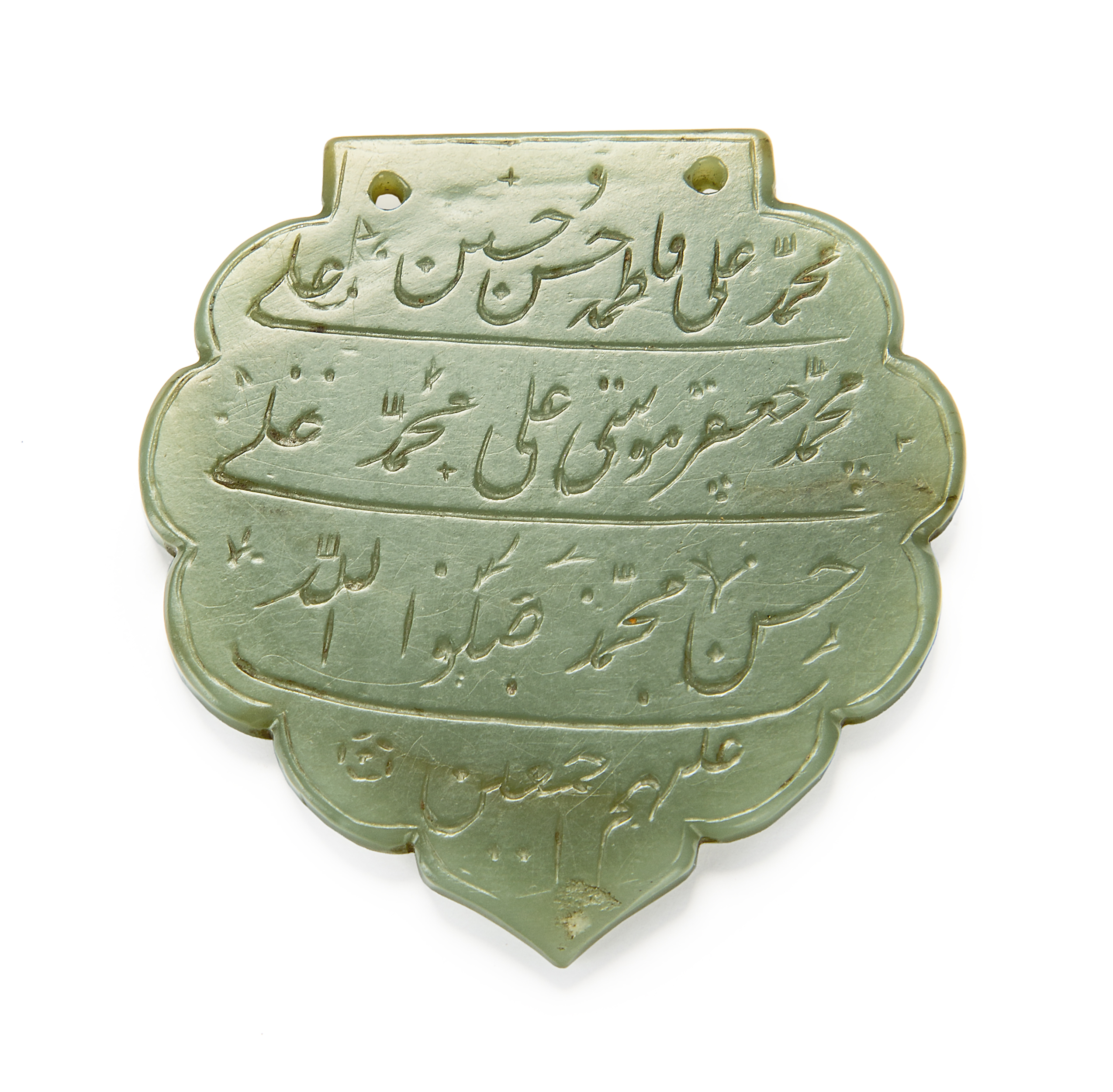 A jade lobed calligraphic pendant (haldili), India, 17th-18th century, inscribed with four lines ...