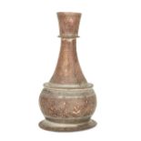 An engraved copper vase, North India, 19th century, of drop-shaped form on a flaring foot, rising...