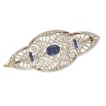 A diamond and sapphire quatrefoil brooch/pendant, the central oval sapphire to openwork millegrai...