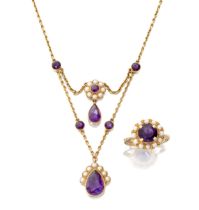 An Edwardian amethyst and seed pearl necklace, designed with two pear-shaped amethyst drops to se...