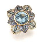 Zorab. An aquamarine and gem set flowerhead ring, a round mixed-cut aquamarine, collet set, to pe...