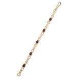 A 9ct gold garnet bracelet, a series of oval cabochon garnets, collet set, with elongated and sti...